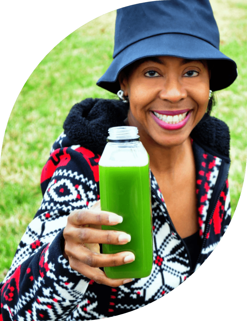 Smiling woman holding a green juice bottle.